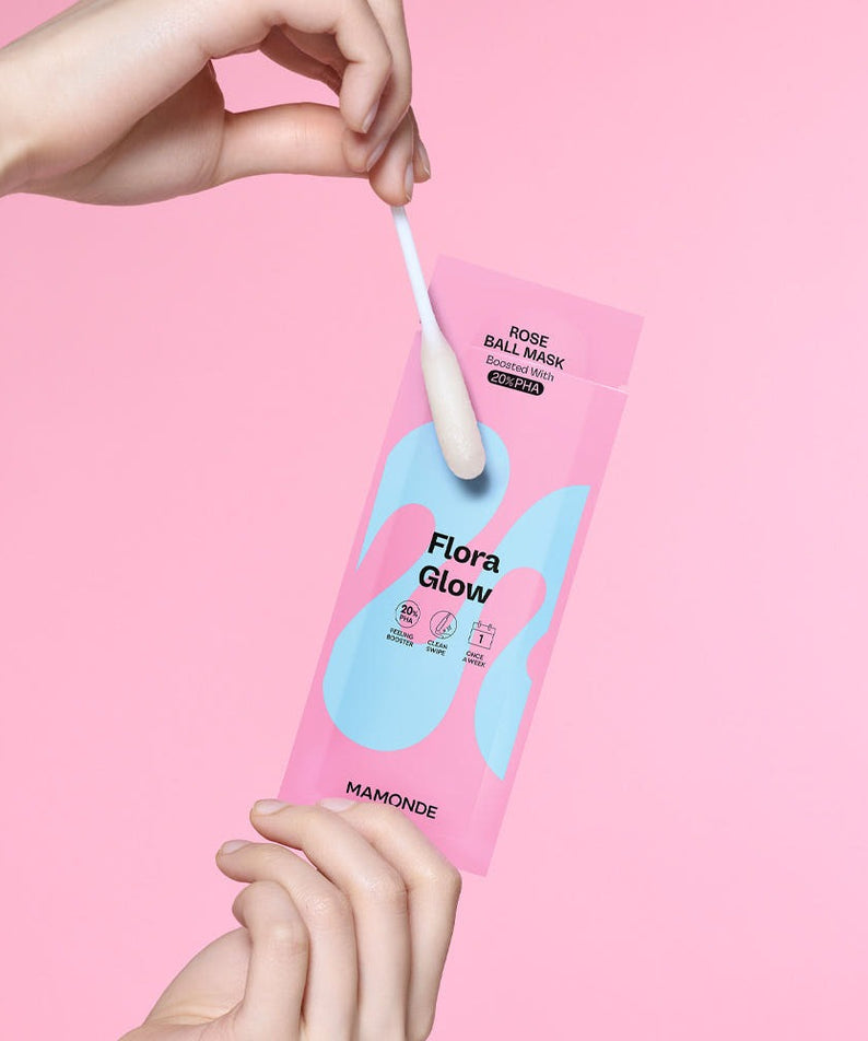 Close-up of MAMONDE Flora Glow Rose Ball Mask 3.5ml with swab on pink background