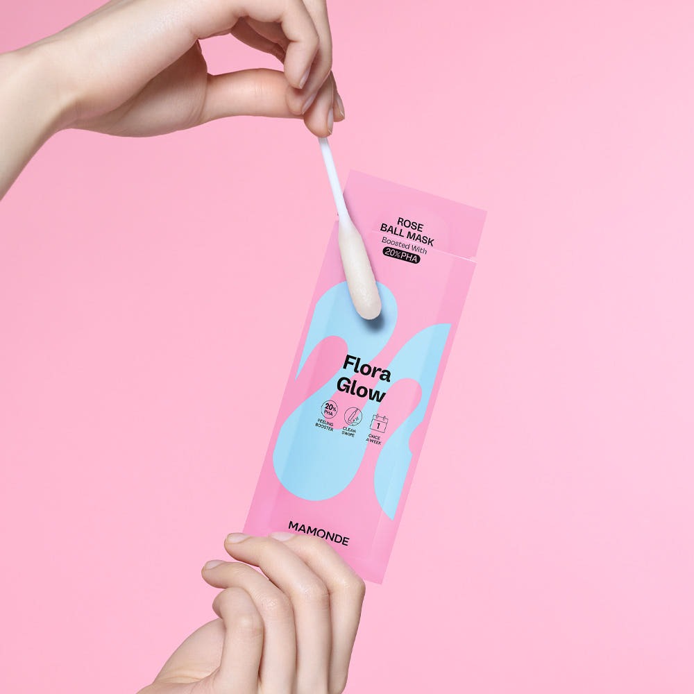 Close-up of MAMONDE Flora Glow Rose Ball Mask 3.5ml with swab on pink background