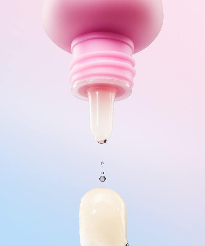 Close-up of MAMONDE Flora Glow Rose Ball Mask 3.5ml applicator with cream droplet against pastel background.