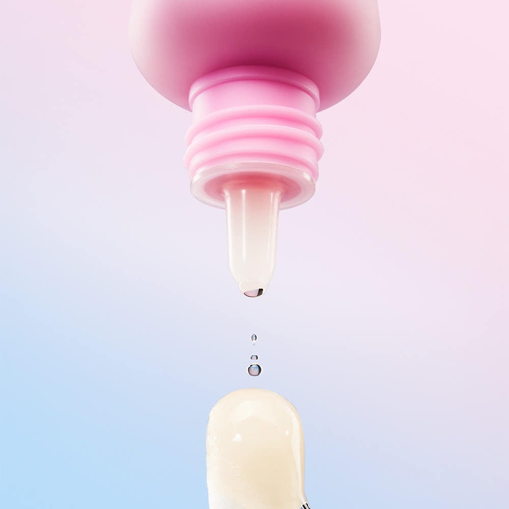 Close-up of MAMONDE Flora Glow Rose Ball Mask 3.5ml applicator with cream droplet against pastel background.