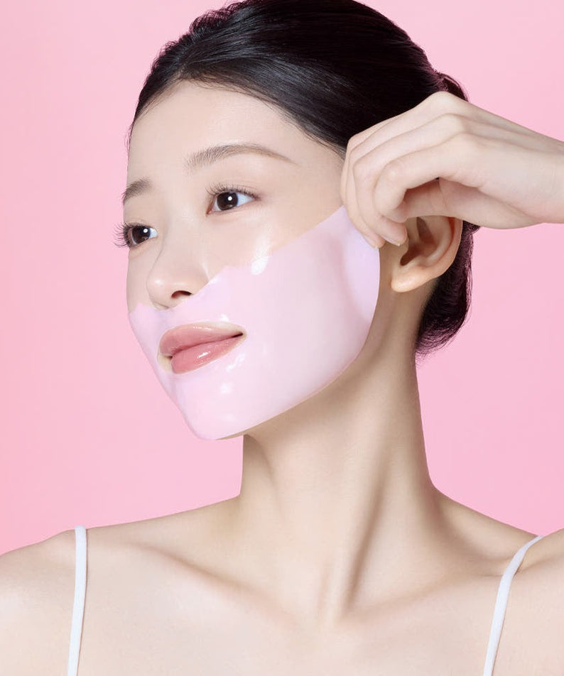 Woman applying MAMONDE Flora Glow Rose Hydrogel Mask 1 sheet on her face