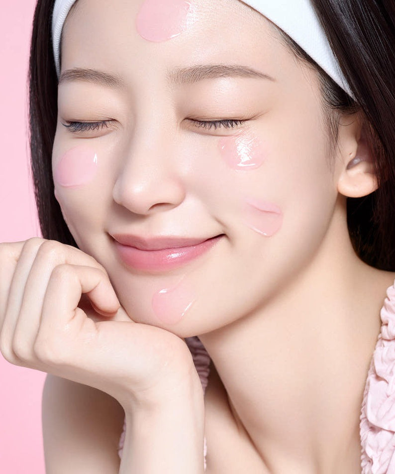 Woman applying MAMONDE Flora Glow Rose Sleeping Mask 80ml on her face, showcasing the skincare product's hydrating properties.
