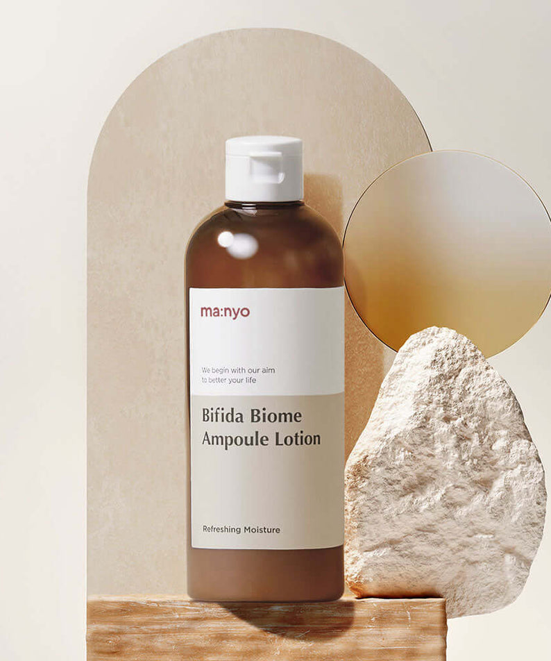 MANYO Bifida Biome Ampoule Lotion 300ml displayed against a stone backdrop, showcasing its refreshing moisture formula in a 300ml bottle.