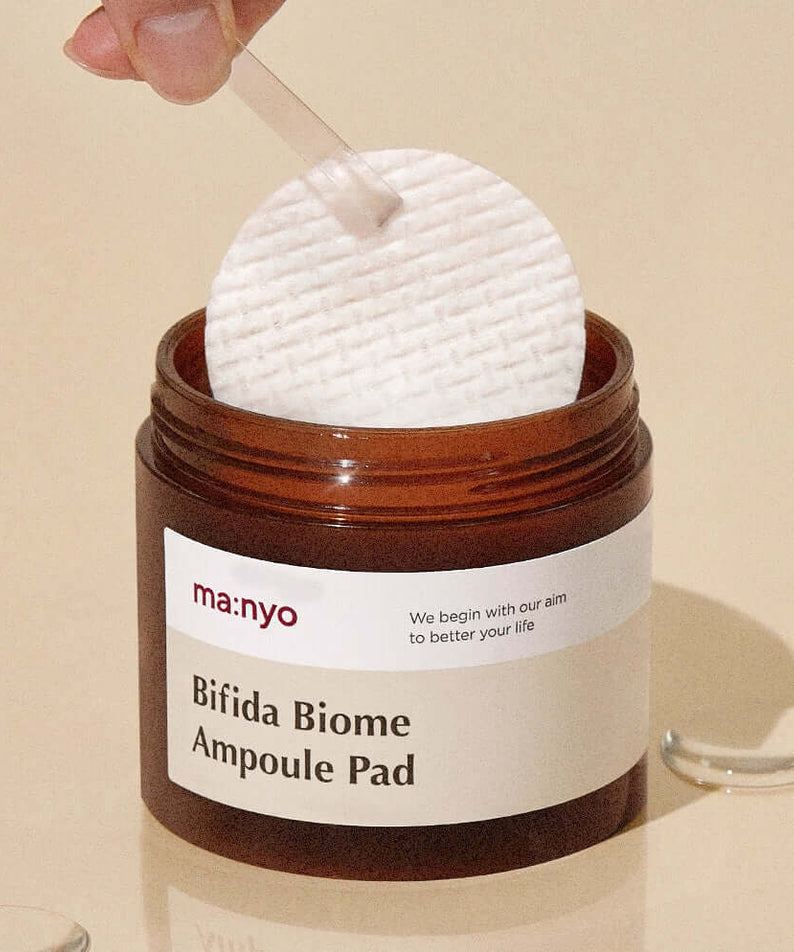 MANYO Bifida Biome Ampoule Pad 70 Sheets in jar, skincare product on beige background
