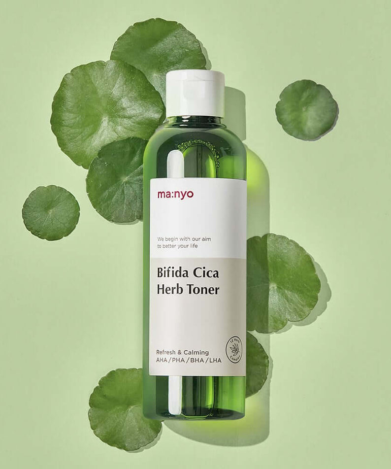 MANYO Bifida Cica Herb Toner 210ml bottle on a green leaf background