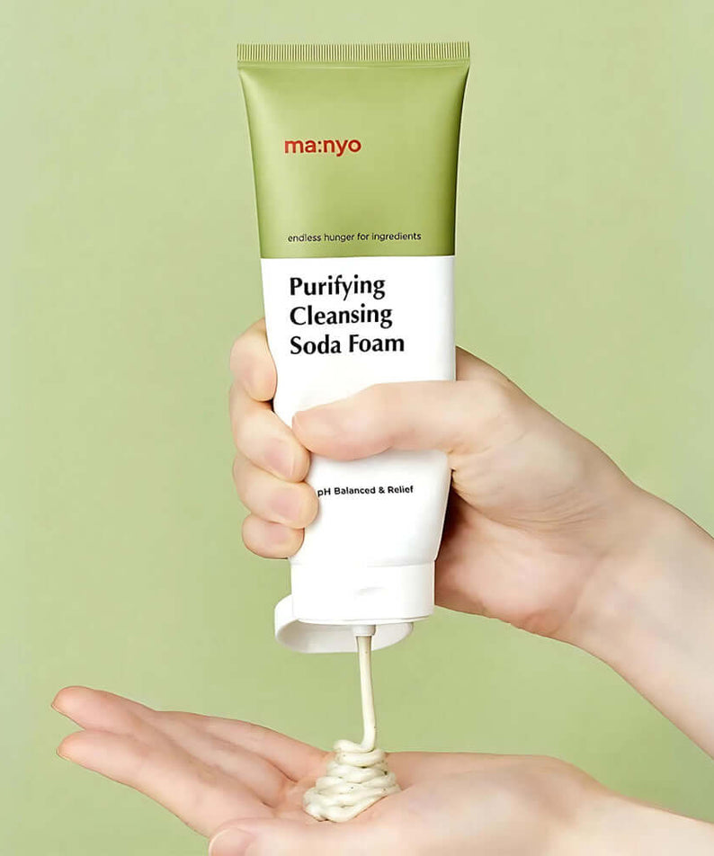 Person dispensing MANYO Deep Pore Cleansing Soda Foam 150ml from tube into hand