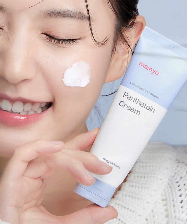 Woman applying MA:NYO Panthetoin Cream 80ml to her face, holding the product tube, showcasing skincare benefits.
