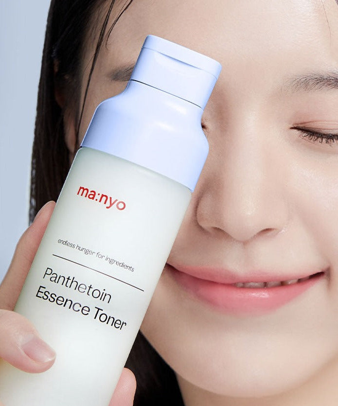 MA:NYO Panthetoin Essence Toner 200ml being held by a person with radiant skin