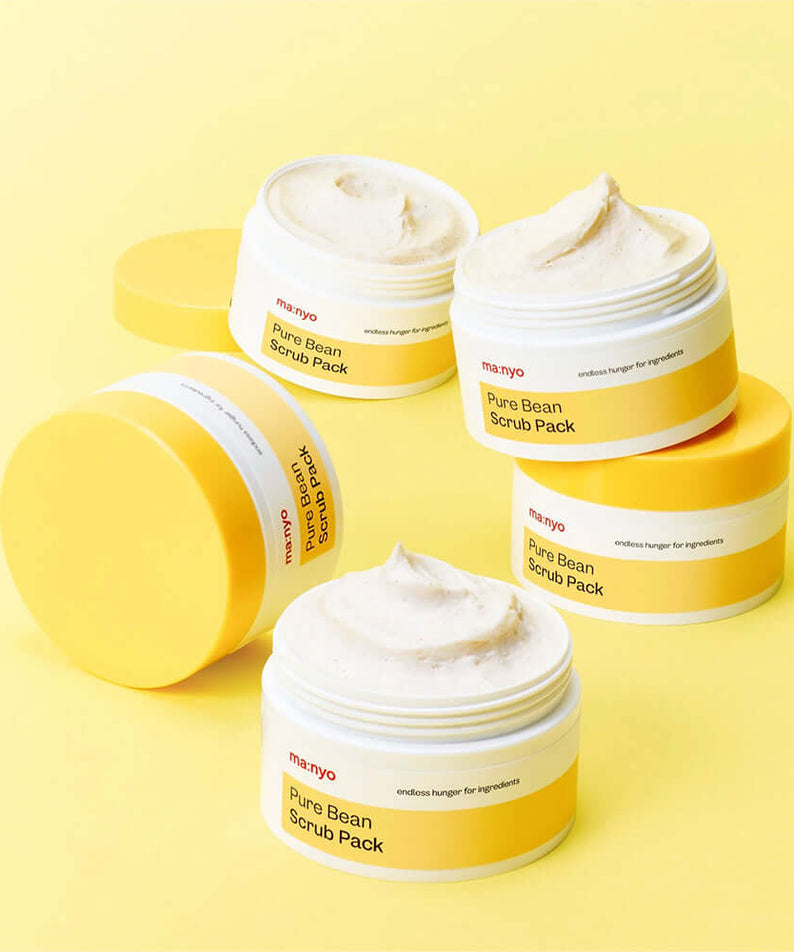 MANYO Pure Bean Scrub Pack 100ml jars on a yellow background, showcasing skincare product design and texture.