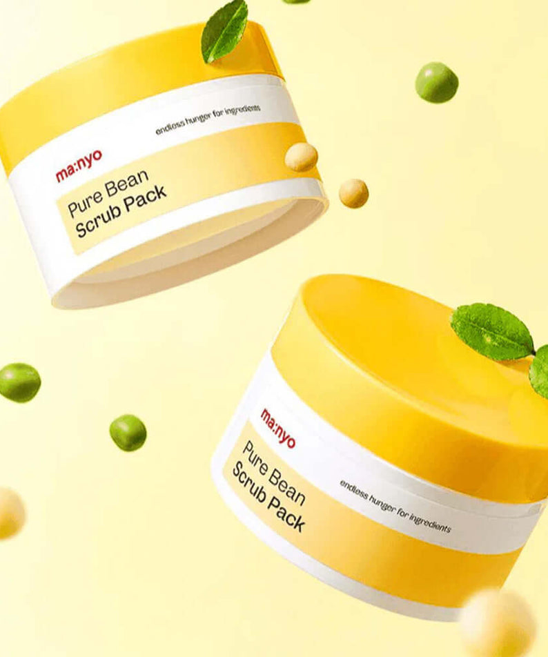 MANYO Pure Bean Scrub Pack 100ml in yellow container with scattered beans and leaves, enhancing skincare routine.