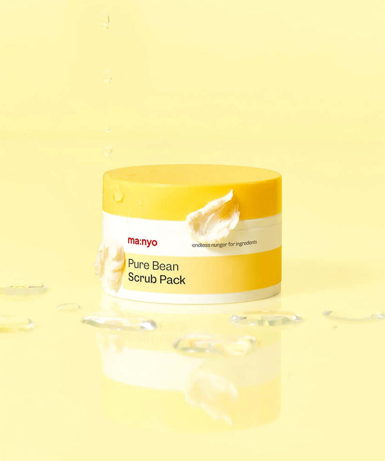 MANYO Pure Bean Scrub Pack 100ml jar with creamy texture on a yellow background