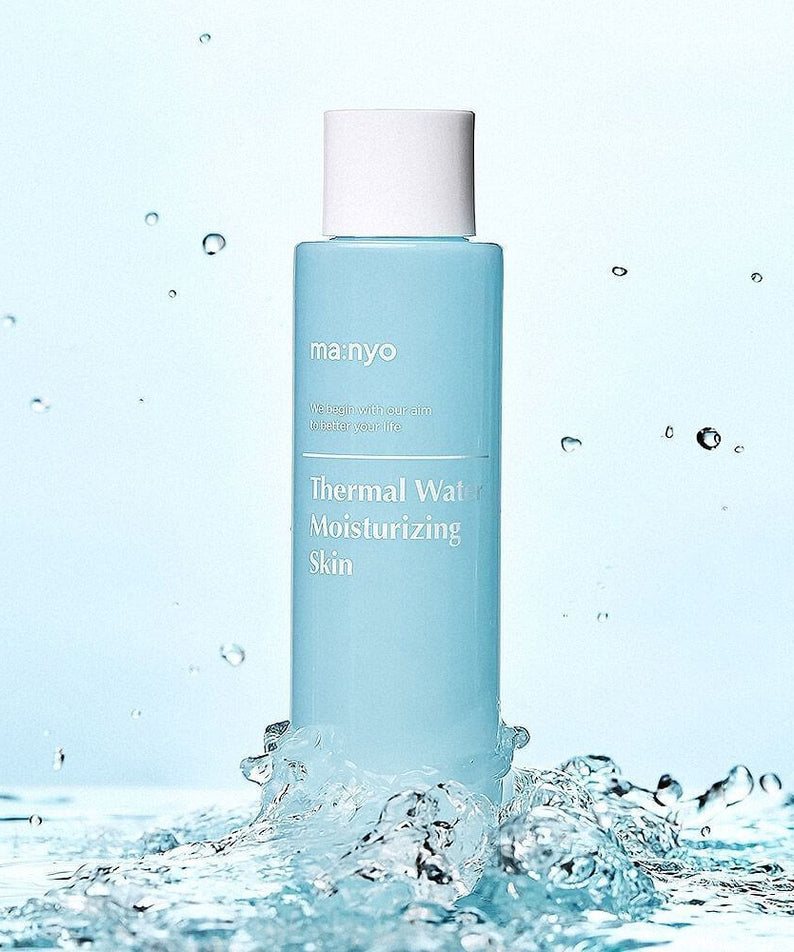 MANYO Thermal Water Moisturizing Skin 155ml bottle amidst splashing water, ideal for skincare hydration.