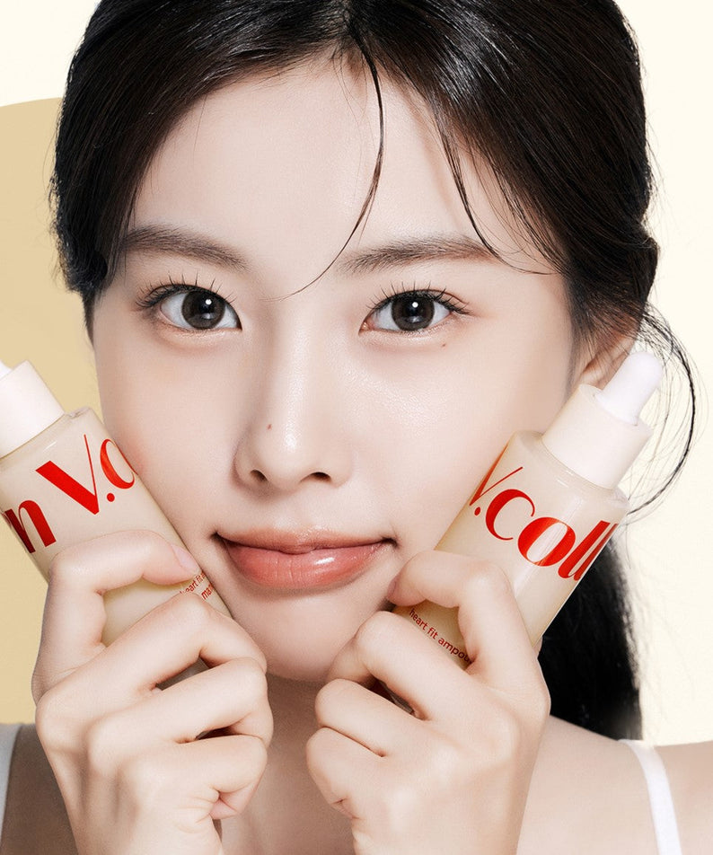Woman holding two bottles of MA:NYO V.Collagen Heart Fit Ampoule 50ml in front of her face.