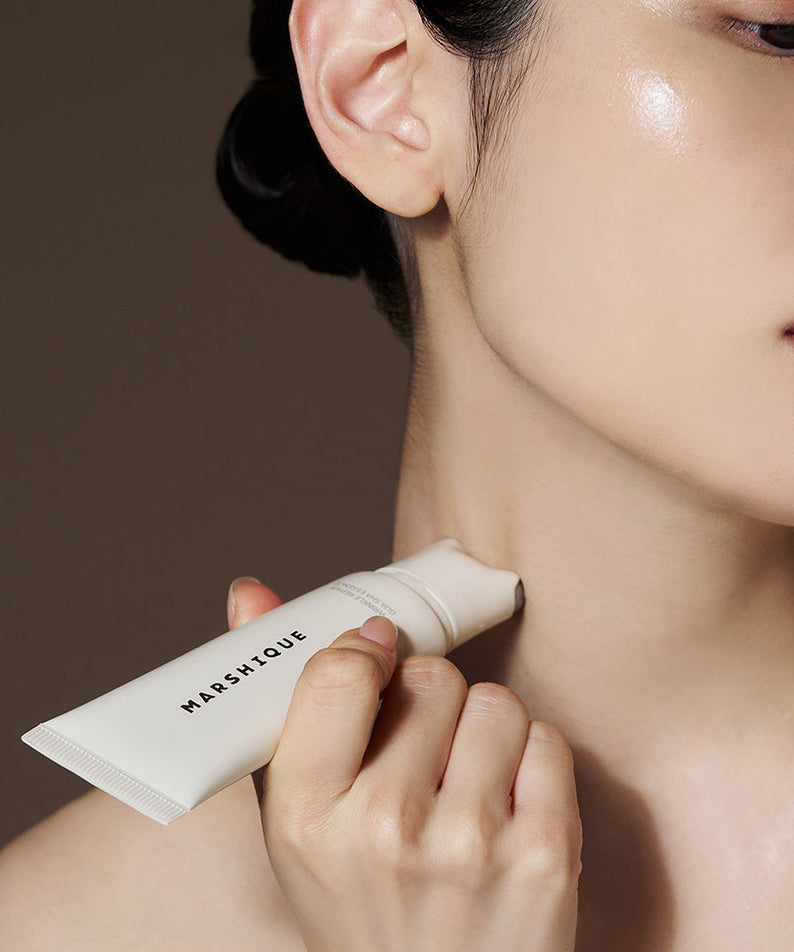 Applying MARSHIQUE Wrinkle Repair Guasha Essence 45ml to neck for skincare routine