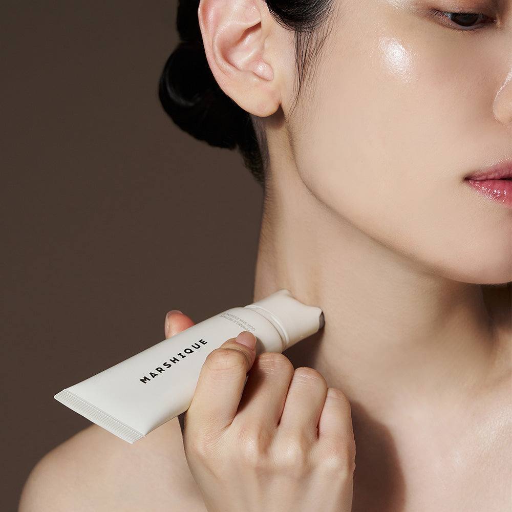 Applying MARSHIQUE Wrinkle Repair Guasha Essence 45ml to neck for skincare routine