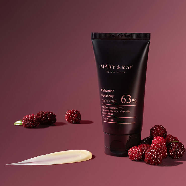MARY & MAY Idebenone Blackberry Intense Cream displayed with blackberries on a burgundy background.