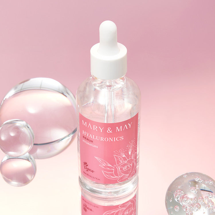 MARY&MAY Hyaluronic Serum 80ml bottle on a pink background with decorative glass elements