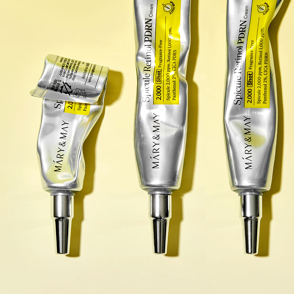 Three tubes of MARY&MAY Speculum Retinol PDRN Cream 15g on a yellow background