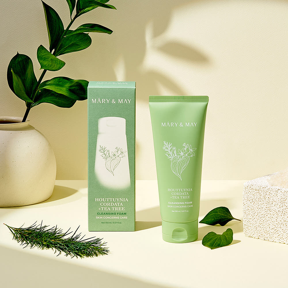 MARY&MAY Tea Tree Pore Cleansing Foam 150ml with packaging, displayed with green leaves and natural light background.