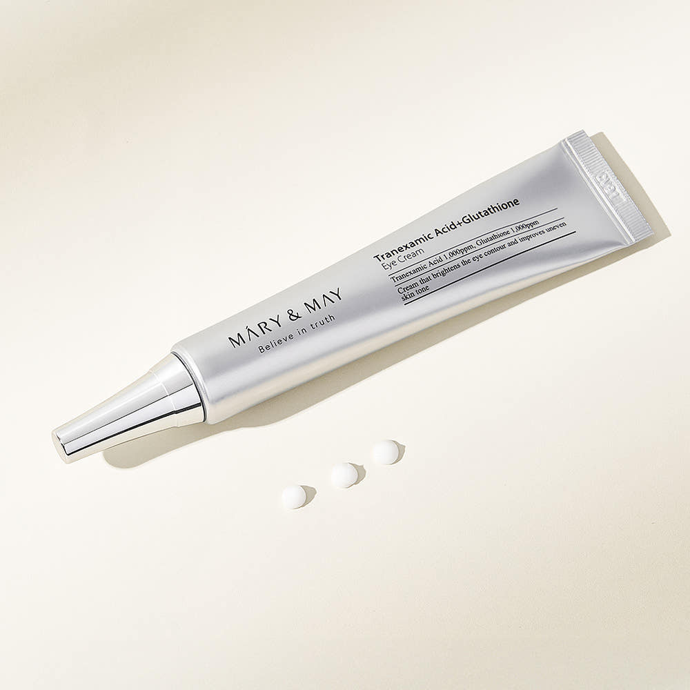MARY&MAY Tranexamic Acid Glutathione Eye Cream 30ml tube with product samples on a light background.