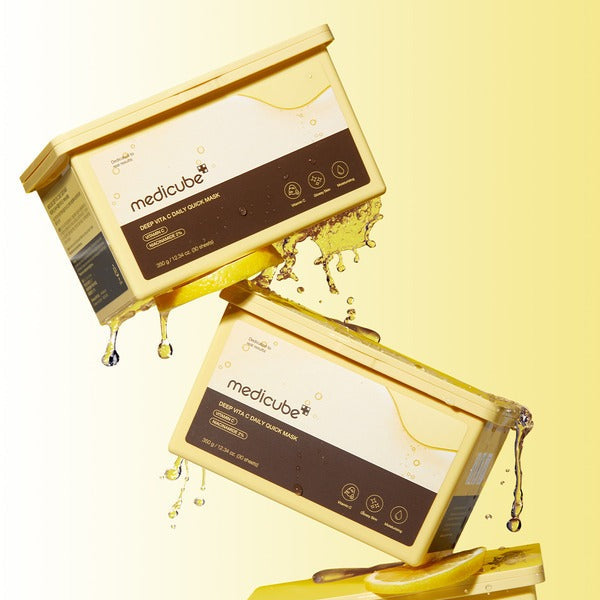 Stacked boxes of MEDICUBE Deep Vita C Daily Quick Mask 30 Sheets with vibrant yellow liquid dripping, showcasing packaging details.