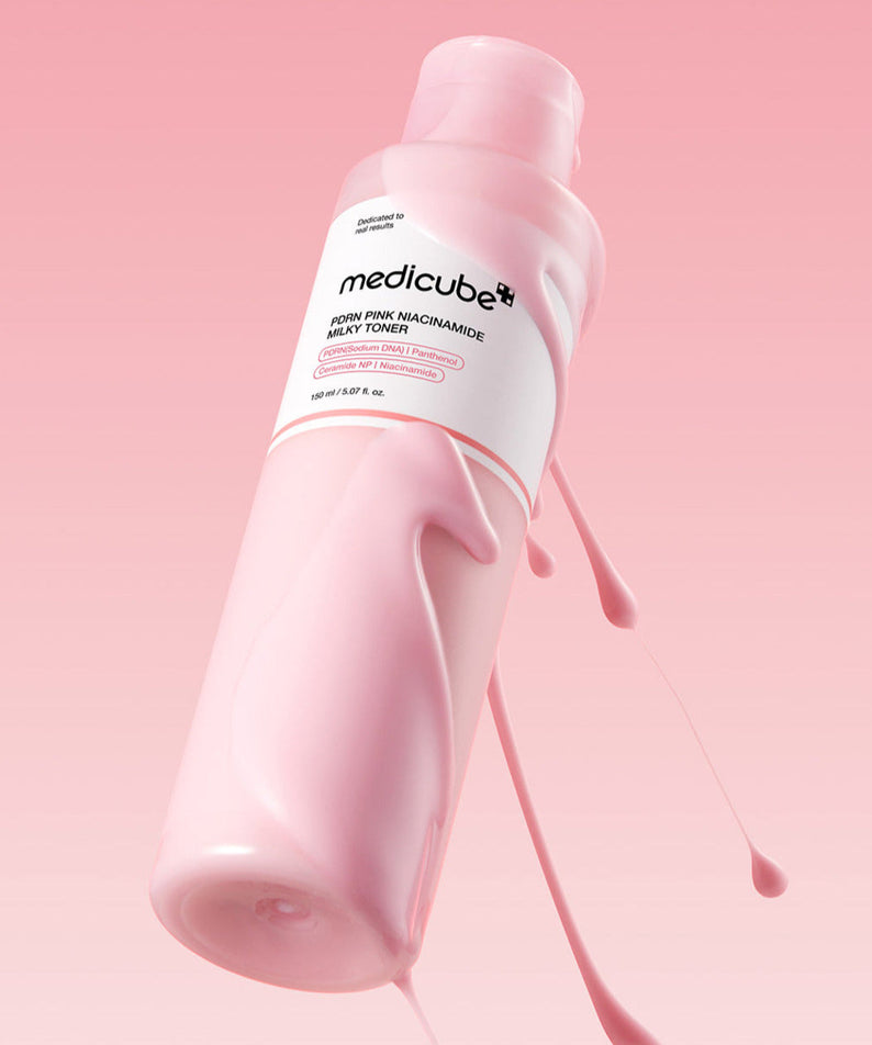 MEDICUBE PDRN Milky Toner Essence 150ml bottle against pink background
