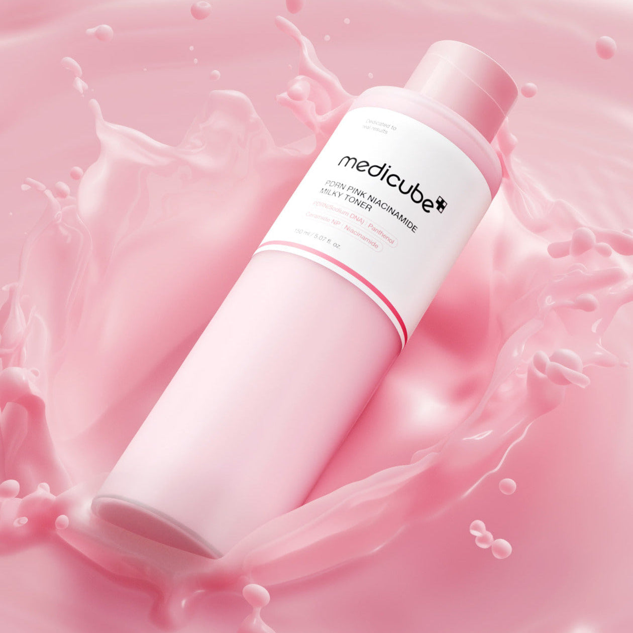 MEDICUBE PDRN Milky Toner Essence 150ml bottle surrounded by pink splash background