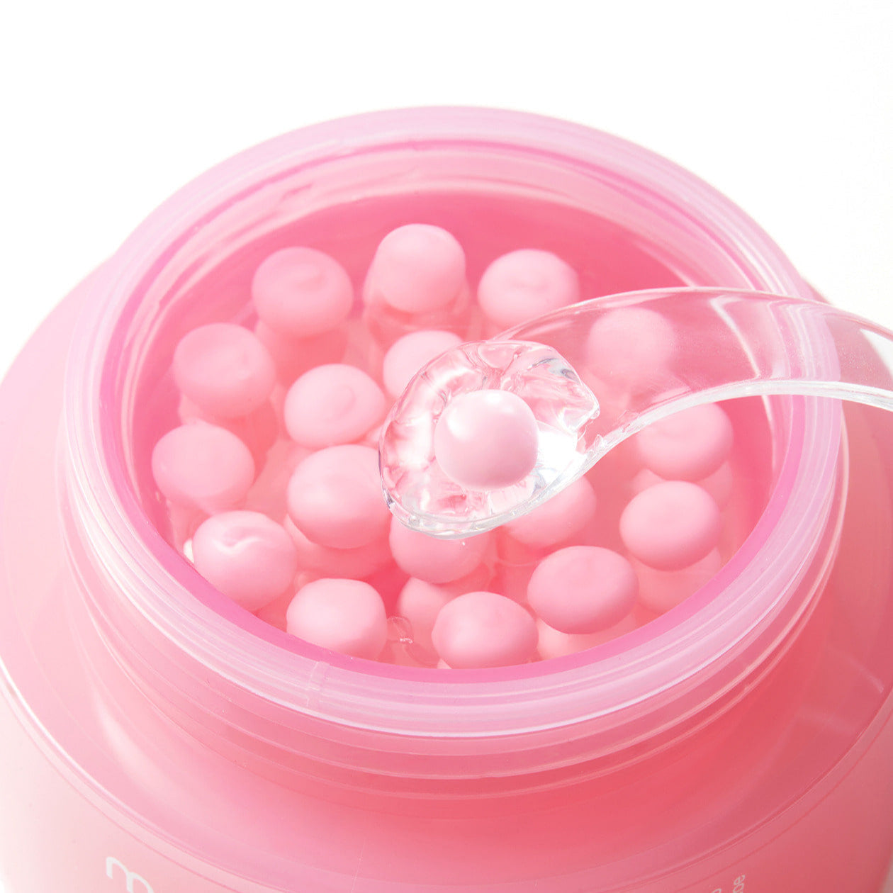 Open jar of MEDICUBE PDRN Pink Collagen Capsule Cream 55g with visible pink capsules and a clear spoon.