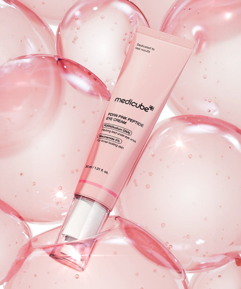 MEDICUBE PDRN Pink Peptide Eye Cream 30ml tube on a bubble background for skincare rejuvenation