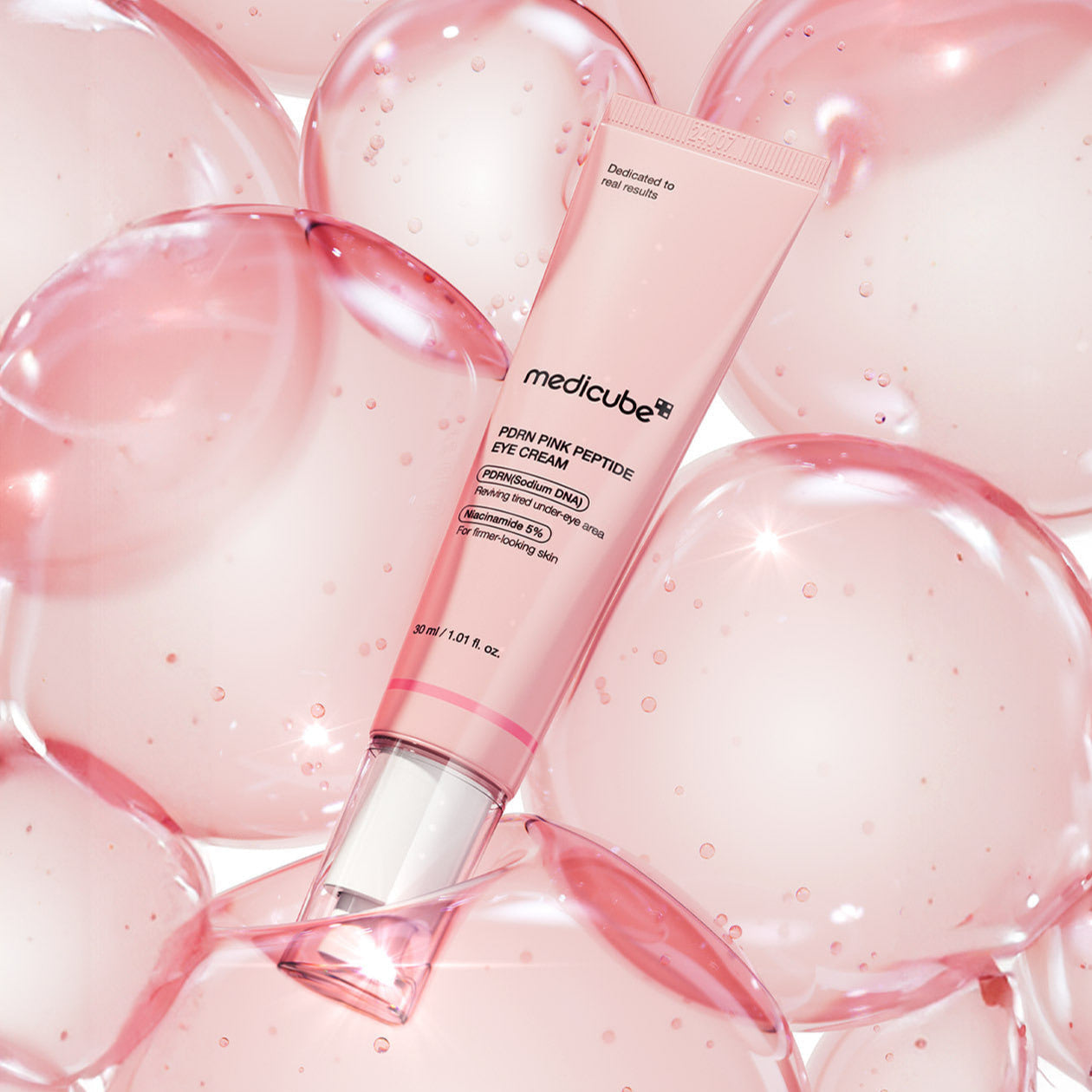MEDICUBE PDRN Pink Peptide Eye Cream 30ml tube on a bubble background for skincare rejuvenation