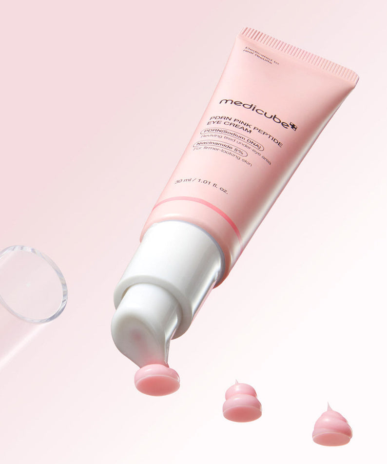 MEDICUBE PDRN Pink Peptide Eye Cream 30ml packaging with cream on a pink background.
