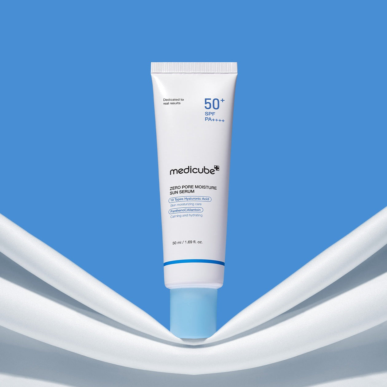 MEDICUBE Zero Pore Moisture Sun Serum 50ml in blue and white packaging against a blue background.