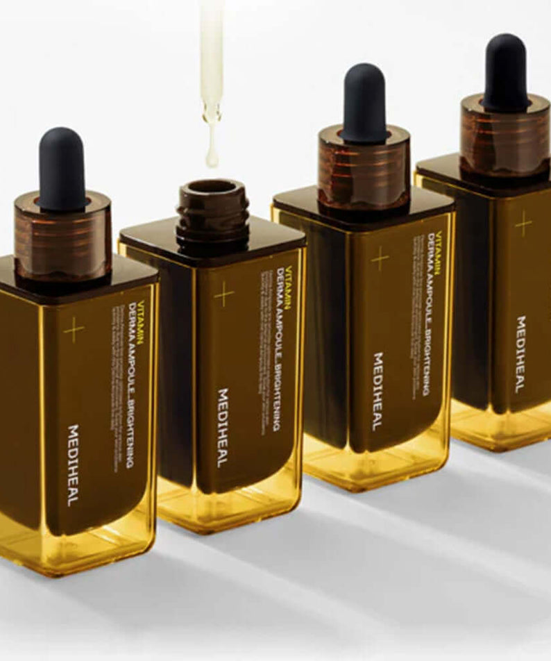 Four bottles of MEDIHEAL Vitamin Derma Ampoule Blemish Whitening 50ml with droppers, showcasing the skin whitening serum.