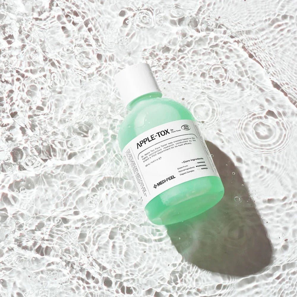 MEDIPEEL Dr.Apple Tox Pore Toner 500ml bottle on rippled water surface