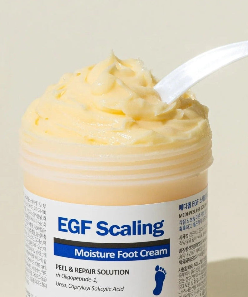 MEDIPEEL EGF Scaling Moisture Foot Cream 130g in open jar showcasing creamy texture with spatula, ideal for repairing dry feet.