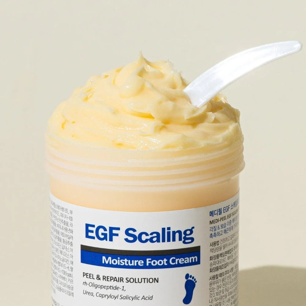 MEDIPEEL EGF Scaling Moisture Foot Cream 130g in open jar showcasing creamy texture with spatula, ideal for repairing dry feet.