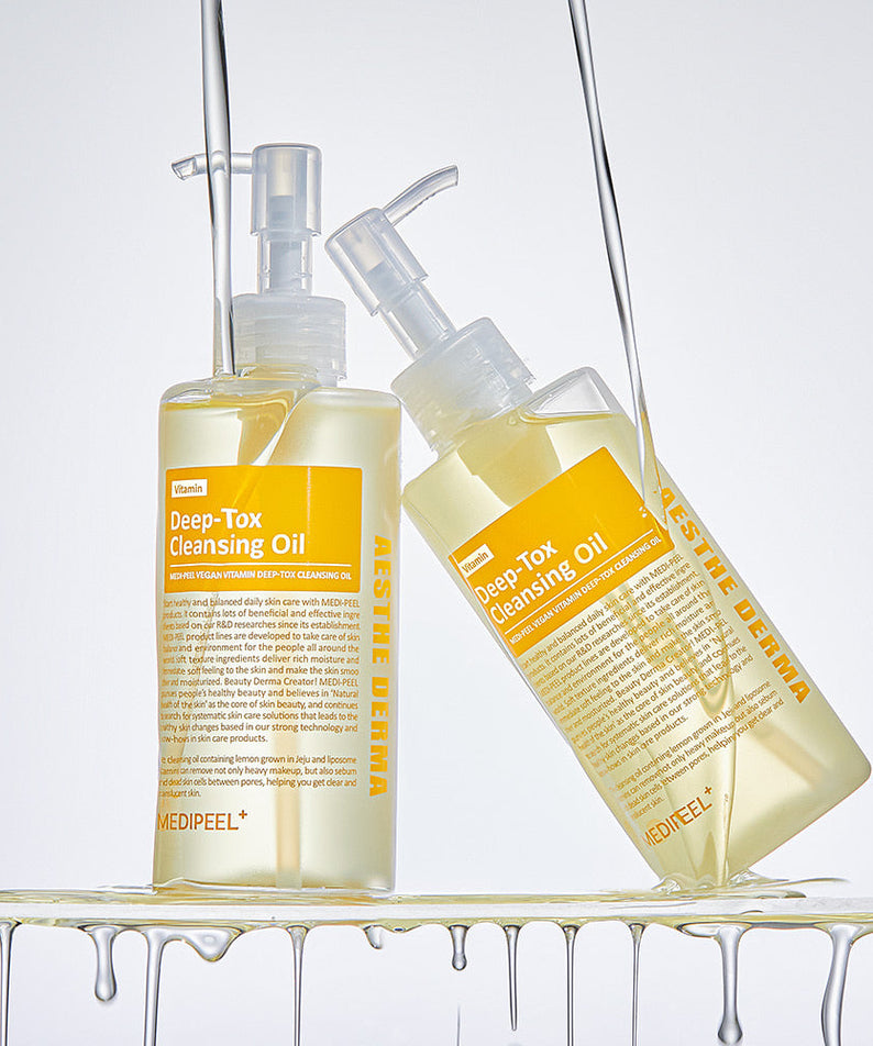 MEDIPEEL Vegan Vitamin Deep Tox Cleansing Oil 200ml displayed with two bottles and oil dripping, highlighting skincare benefits.