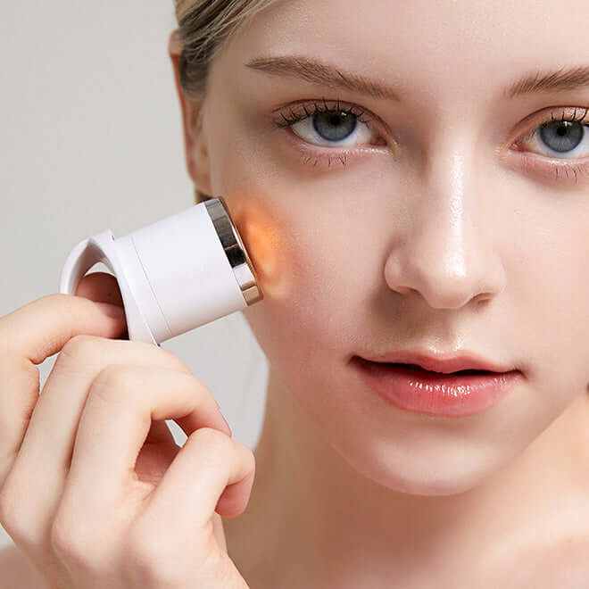 Woman using MEDITHERAPY Melageran White Toning Cream 50ml + EMS Device on her face for skincare treatment