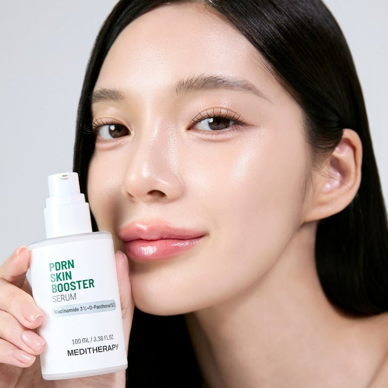 Woman holding MEDITHERAPY PDRN Skin Booster Serum 100ml showing glowing skin
