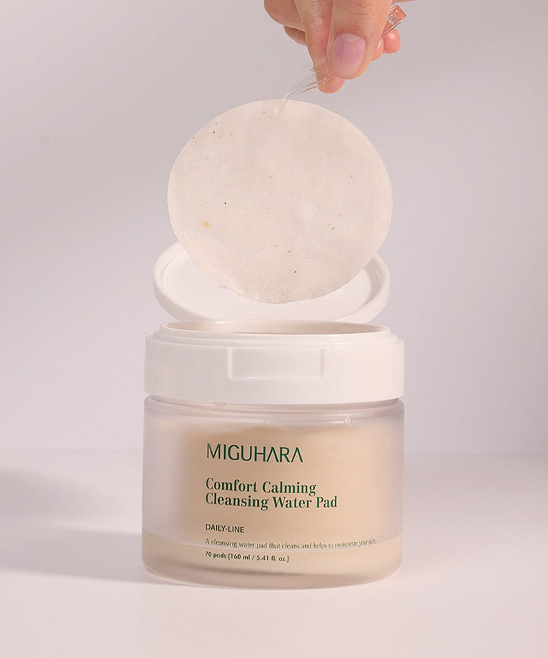 MIGUHARA Comfort Calming Cleansing Water Pads 70 Sheets pack with open lid showcasing one pad being lifted out.