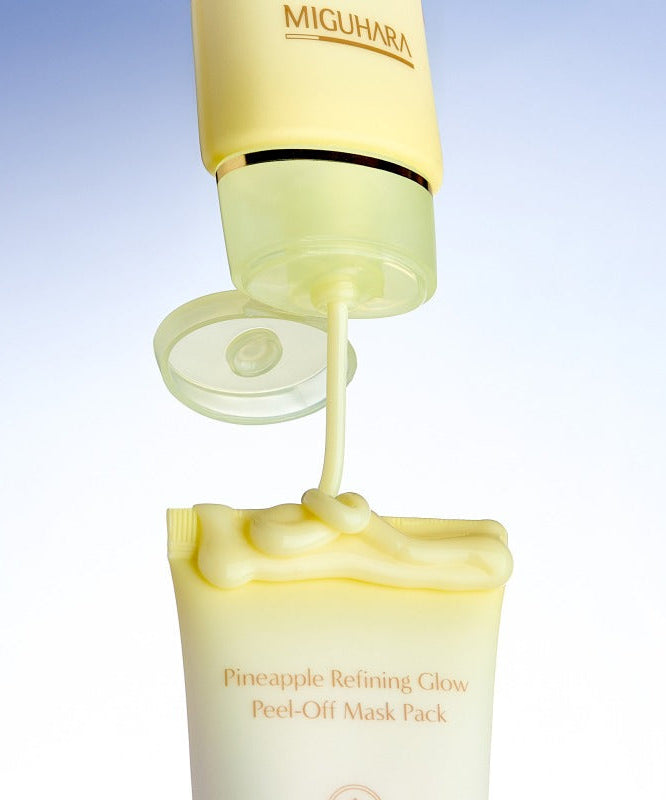 MIGUHARA Pineapple Refining Glow Peel Off Mask Pack 60ml being dispensed from tube against light blue background
