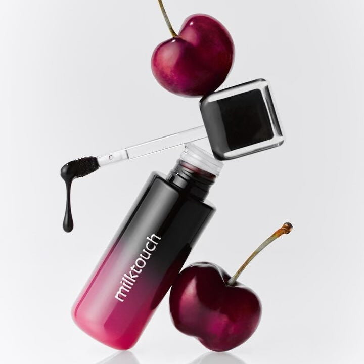 MILK TOUCH Black Peel-Off Lip Tattoo with dark cherry and applicator on a white background.