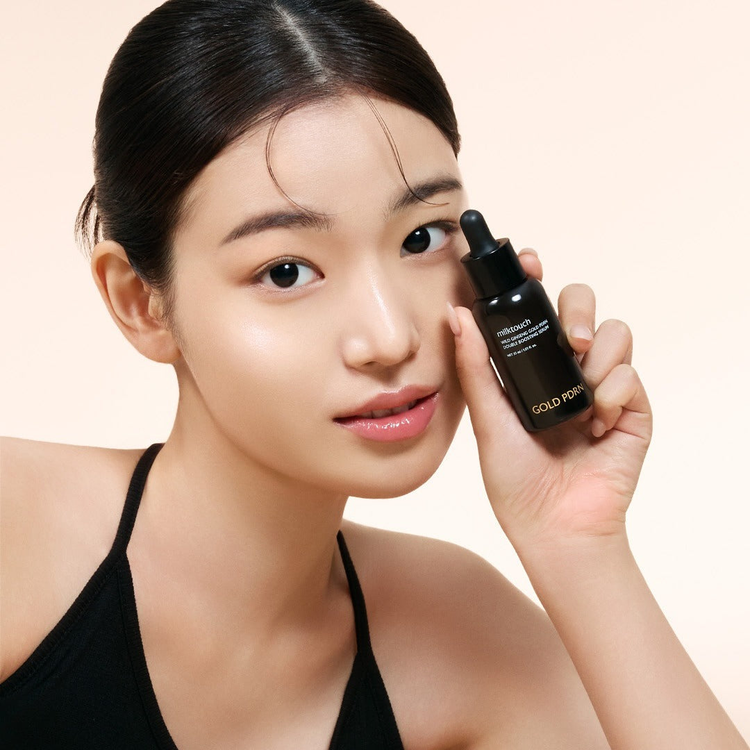 Woman holding MILK TOUCH Ginseng Gold PDRN Double Boosting Serum 30ml with radiant skin