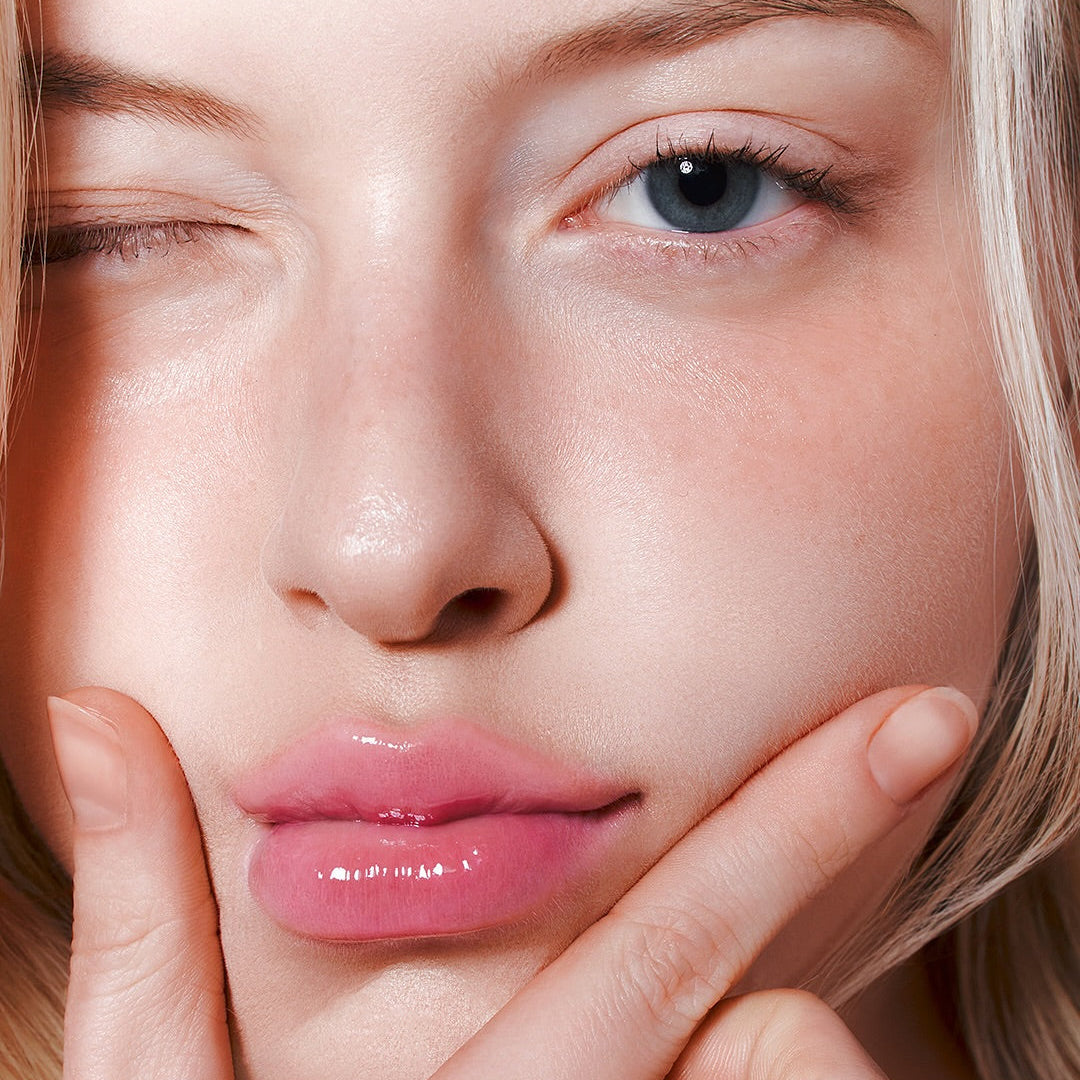 Woman applying MILK TOUCH Glow Up Collagen Lip Balm 15g for plump, glossy lips