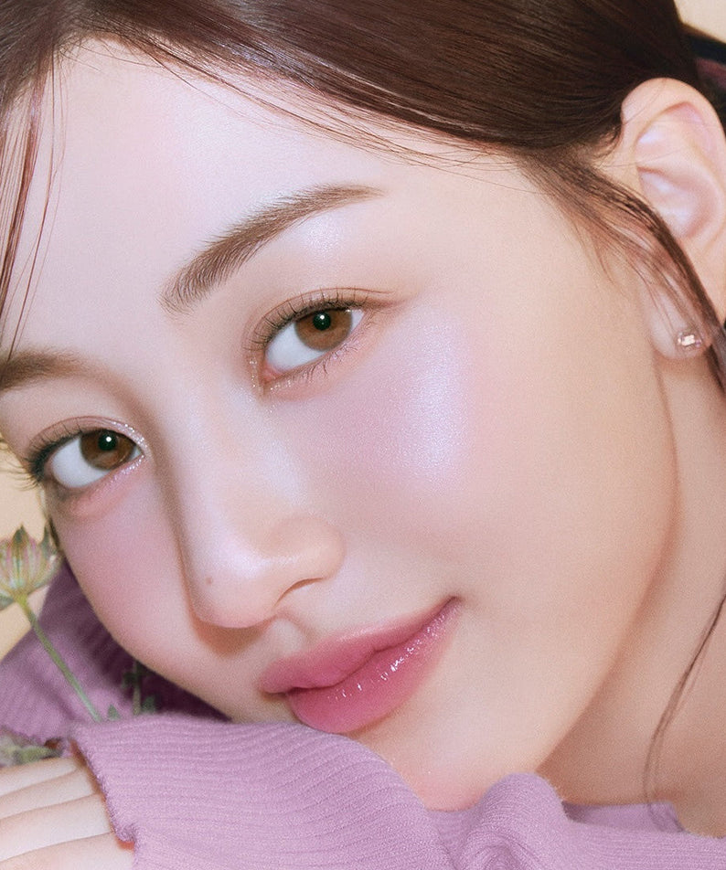 Model wearing MILK TOUCH Tone On Blusher showcasing natural rosy cheeks with a soft focus effect.