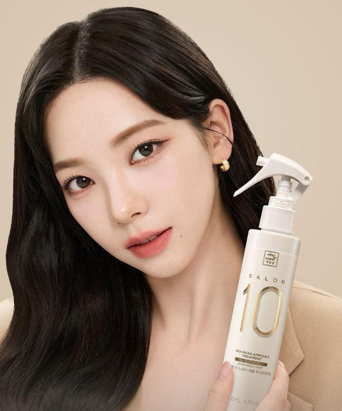 Woman holding MISE EN SCENE Salon 10 No-Wash Extreme Damage Ampoule Treatment 200ml bottle.
