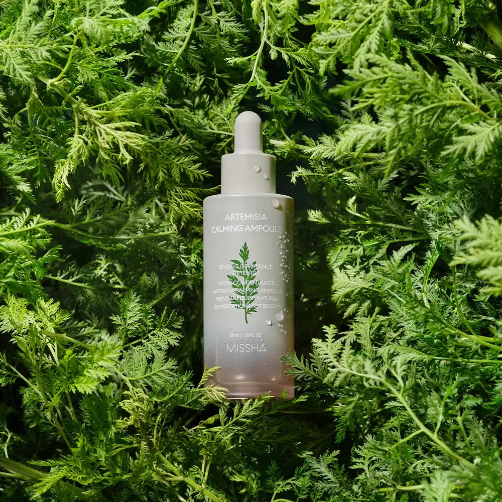 MISSHA Artemisia soothing ampoule 50ml bottle displayed on lush greenery background