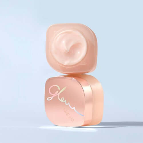 MISSHA Glow Skin Balm 50ml in a pink container with open lid showcasing creamy texture.