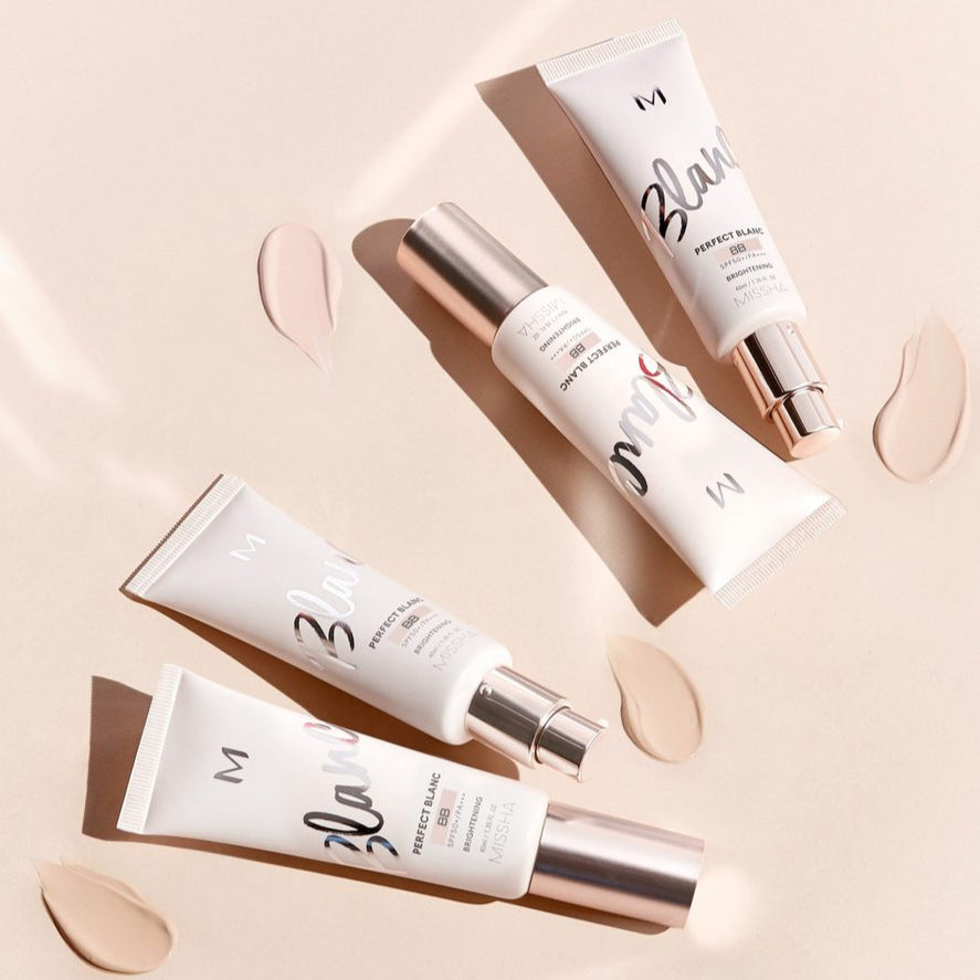 MISSHA M Perfect Blanc BB 40ml skincare tubes on a beige background with swatches.