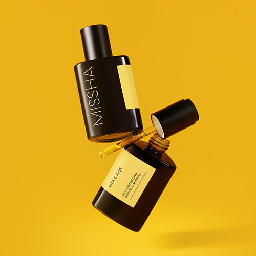 MISSHA Vita C Plus Ascorbic Acid Spot Correcting & Firming Ampoule 75ml product image on a vibrant yellow background.